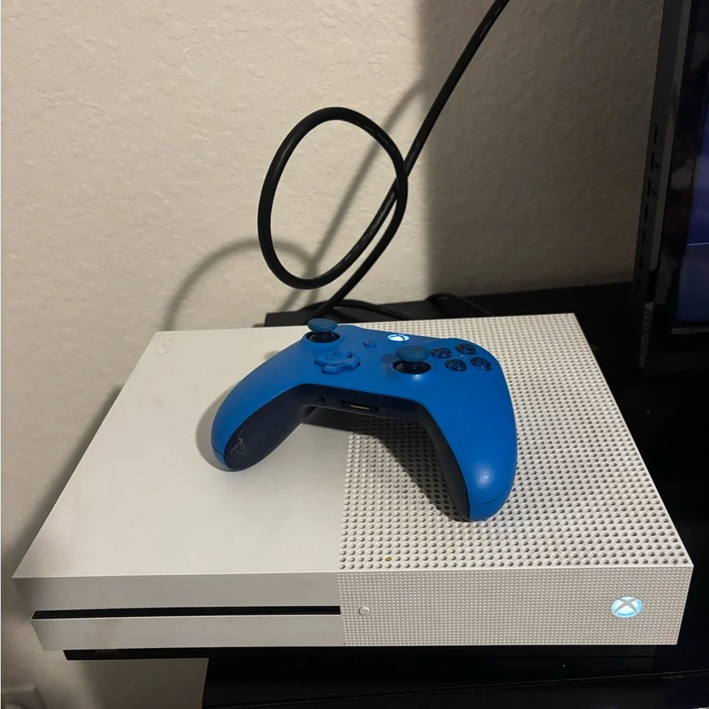 Sleek White Console with Vibrant Blue Controller